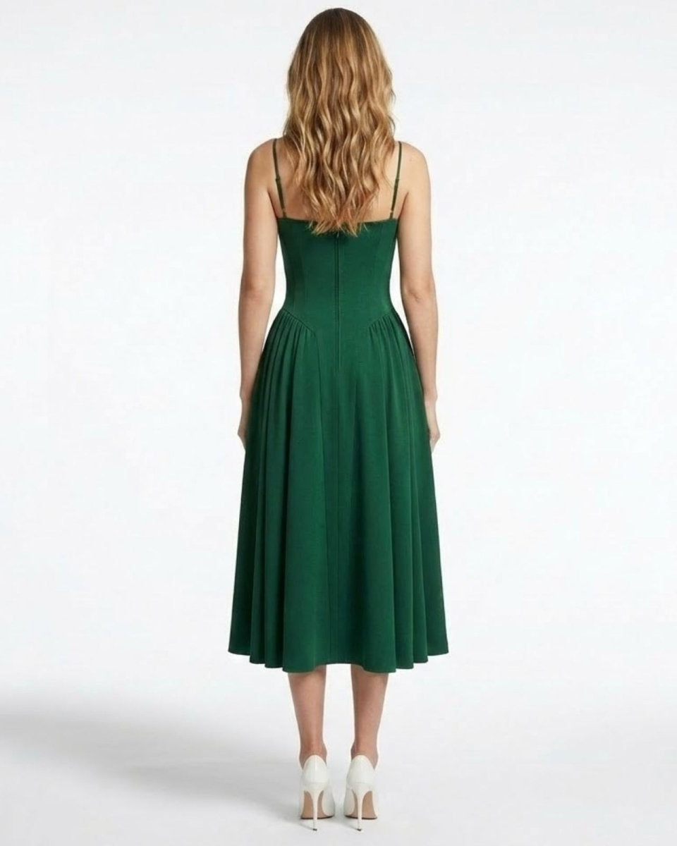 Back view of the Evdokia emerald green dress, detailing the spaghetti straps and seam work on the structured bodice.