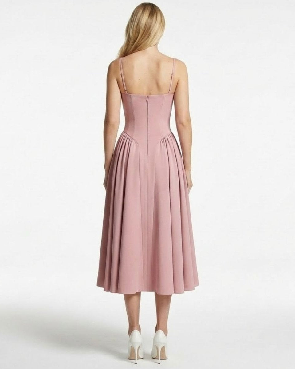 Back view of a model in the Evdokia dress in pink, detailing the spaghetti straps and hidden zipper closure.