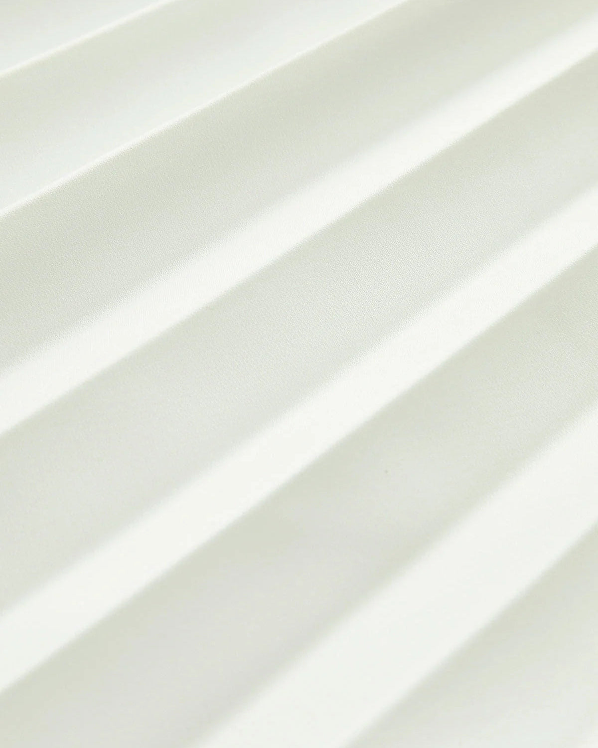 architectural," "sculptural," "asymmetrical," "bonded crepe," and "sunray pleats