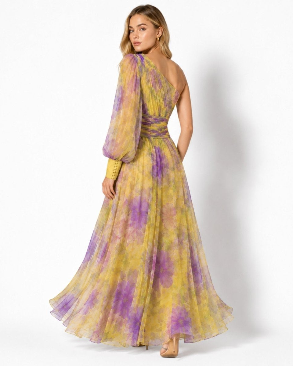 Woman wearing a yellow and purple floral dress on a white background