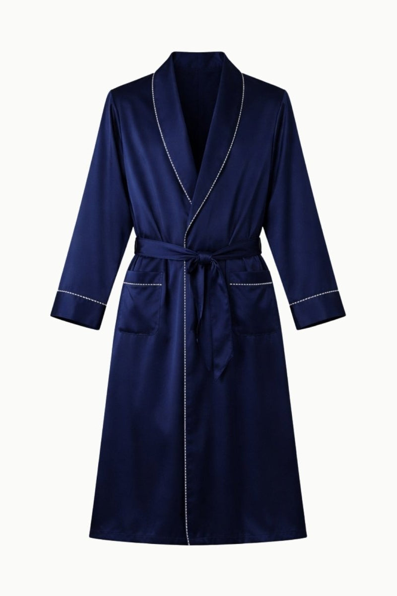 Flat lay of the Fenlo Form men's navy silk robe, showcasing the white piping detail on the collar, pockets, and tie belt.
