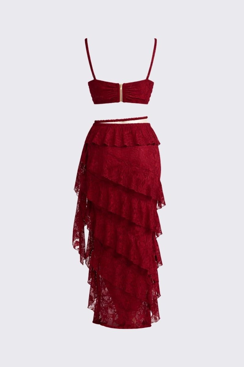 A two-piece red lace set consisting of a strapless bandeau top with a central gold clasp and a matching tiered ruffled skirt, displayed on a solid light gray background.