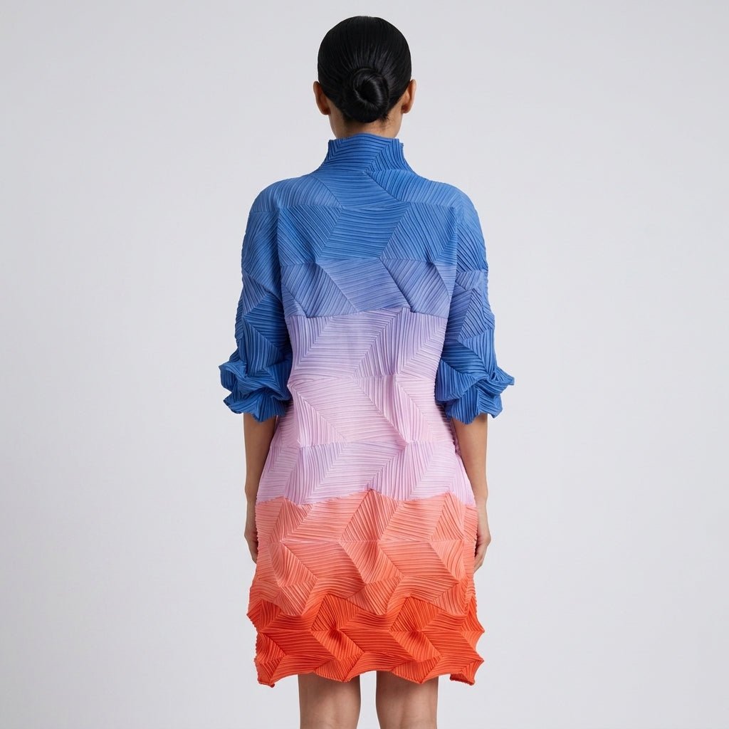  Back view showing the intricate geometric pleats on the Kouvr gradient color block flowing midi dress.