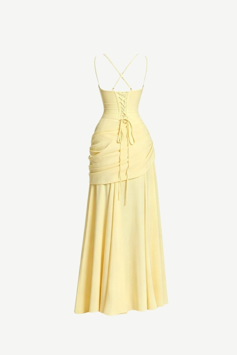 Back view ghost mannequin product photography of a pale yellow formal dress highlighting the strappy corset tie closure and draped skirt.