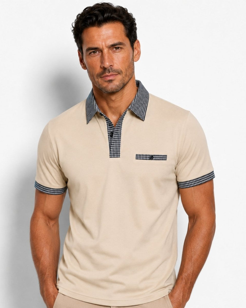 Man wearing a beige polo shirt with blue accents against a plain background