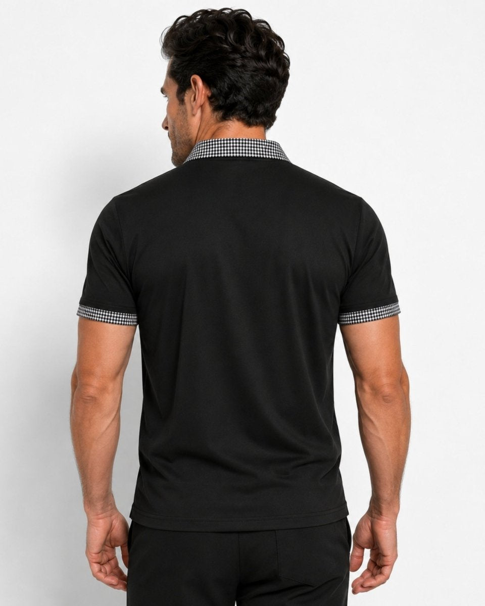 Man wearing a black polo shirt with checkered collar on a white background