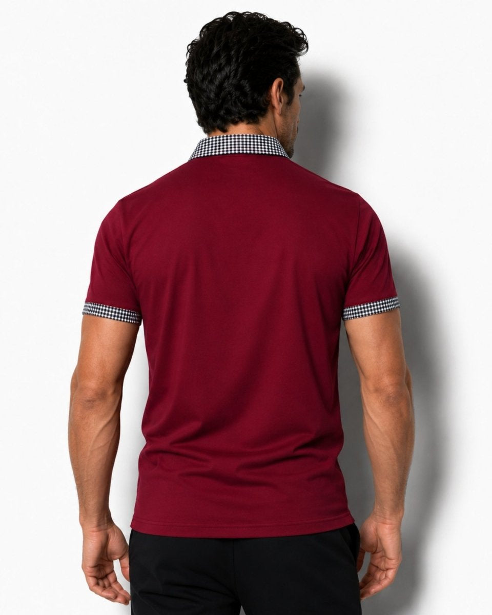 Man wearing a red polo shirt with checkered collar and cuffs on a white background