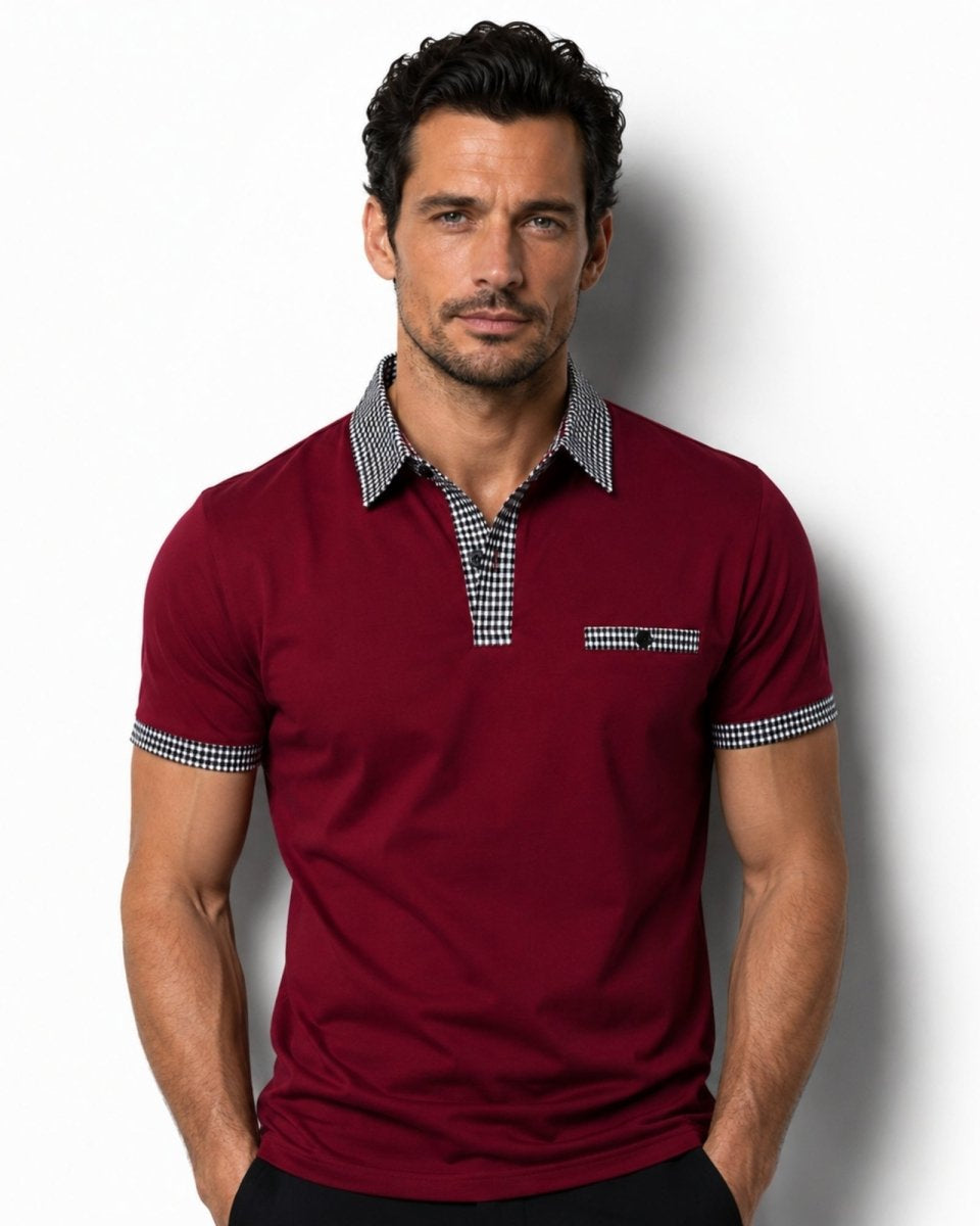 Man wearing a red polo shirt with checkered collar and trim on a white background