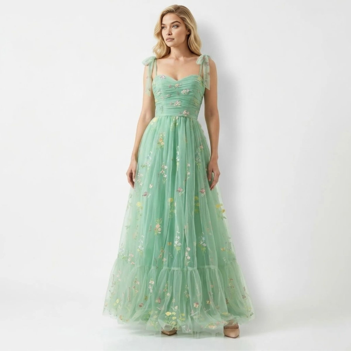 Front view of woman wearing Kouvr green floral embroidered tulle maxi dress with tie straps