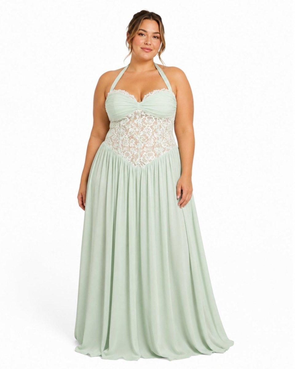 A plus-size model wearing a mint green halter-neck maxi dress with a lace bodice, photographed against a plain white studio background.