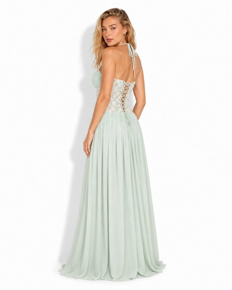 Back angle of the mint green formal dress showcasing the intricate lace-up corset back and flowing pleated skirt.