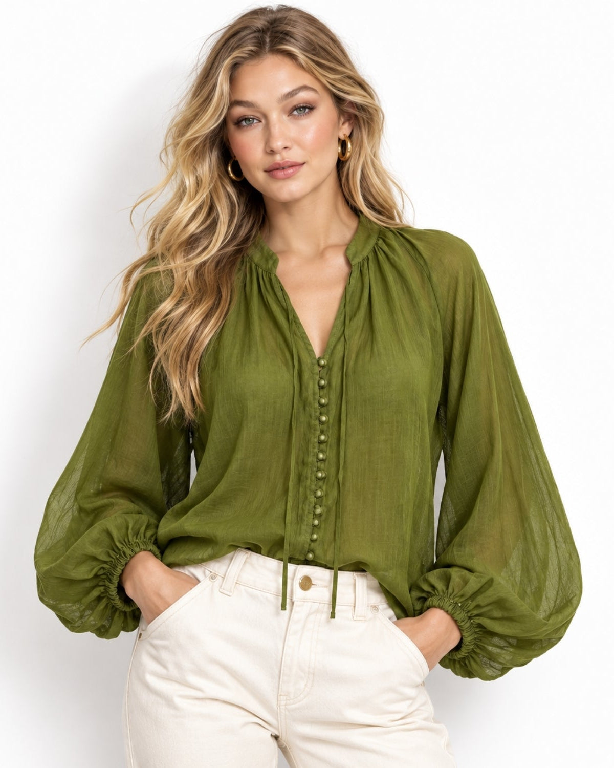 Woman wearing olive green sheer balloon sleeve boho blouse with button front and gathered neckline