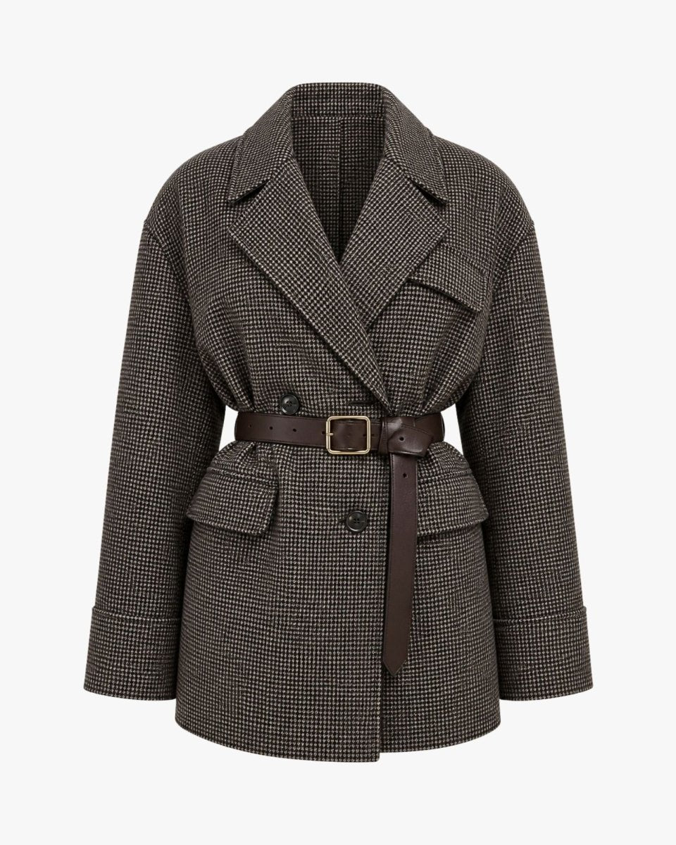 A double-breasted belted coat in a dark brown and black houndstooth pattern, featuring a brown leather-look belt with a gold-tone buckle, shown on a plain light gray background.