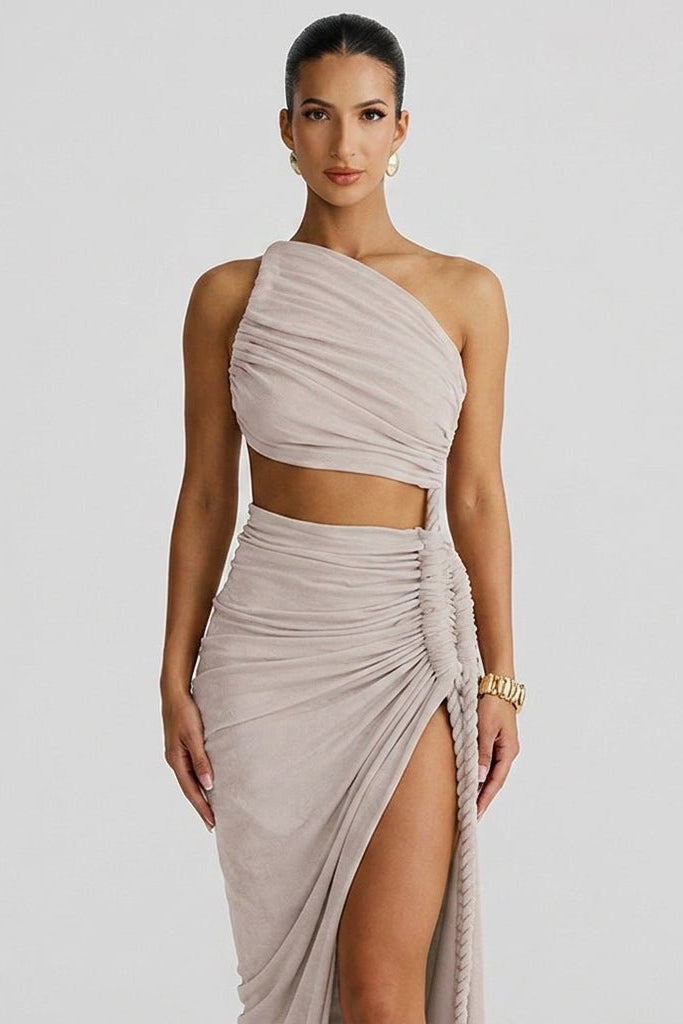 Close up showing draped bodice, waist cutout, and braided rope trim on a taupe high slit maxi dress.