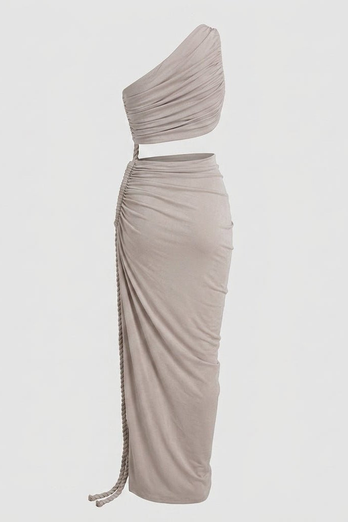 Angled view of a draped grey evening gown with high side slit and rope accent on a light grey background.