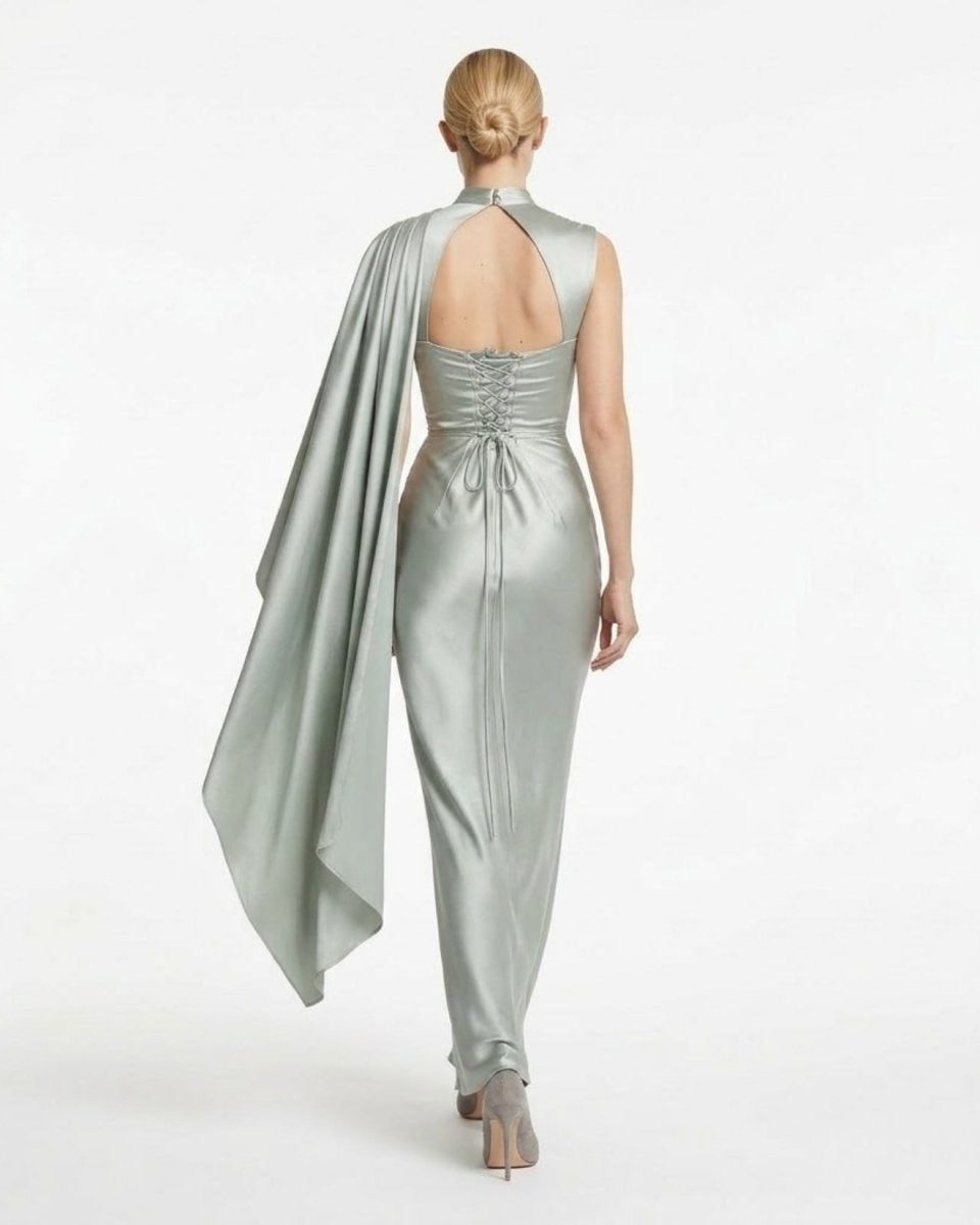 Back view of the sage green satin wedding guest dress highlighting the adjustable corset lace-up back and keyhole cutout.