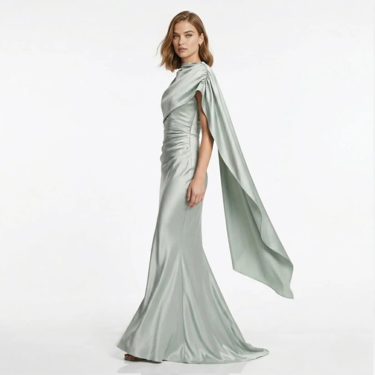 Side profile of Kouvr grey satin evening gown showing dramatic draped cape detail.