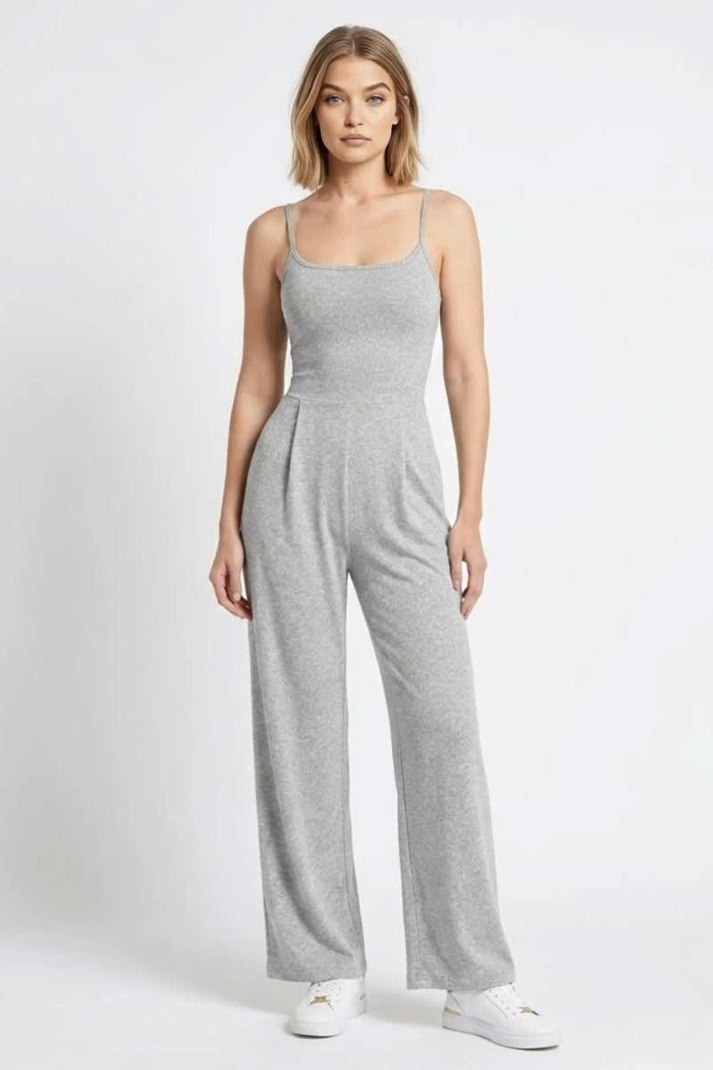 Woman wearing a light grey wide leg sleeveless knit jumpsuit with front pleats by Fenlo Form