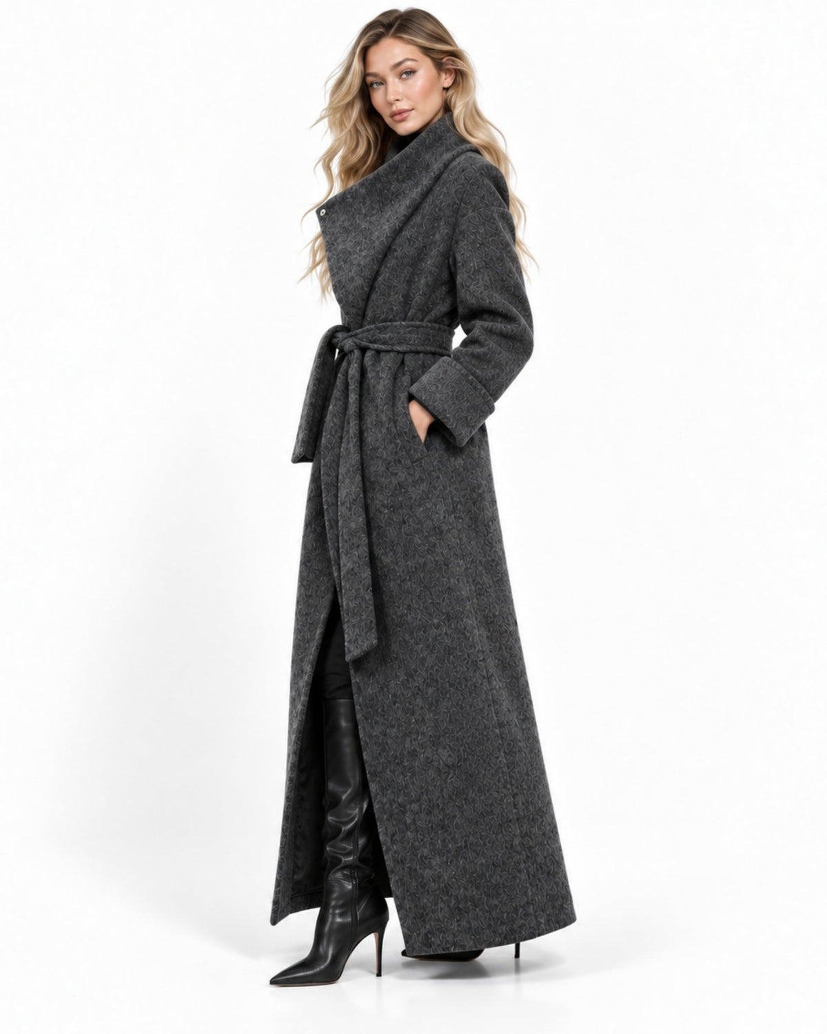 A woman modeling a long charcoal gray wrap coat with a tie belt, paired with black knee-high boots, against a plain white studio background.