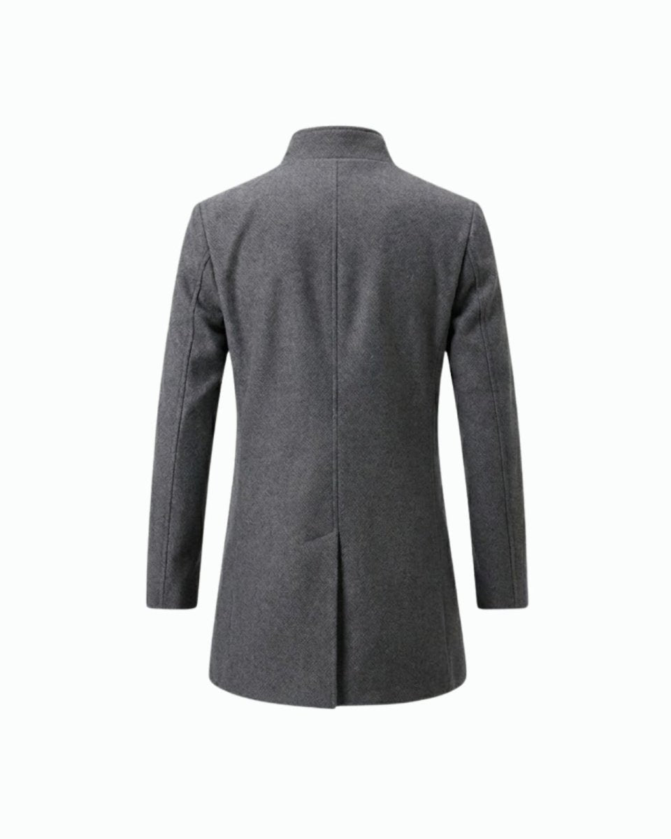 Product-only studio shot of the back of the men's grey wool overcoat, detailing the center seam and single vent.