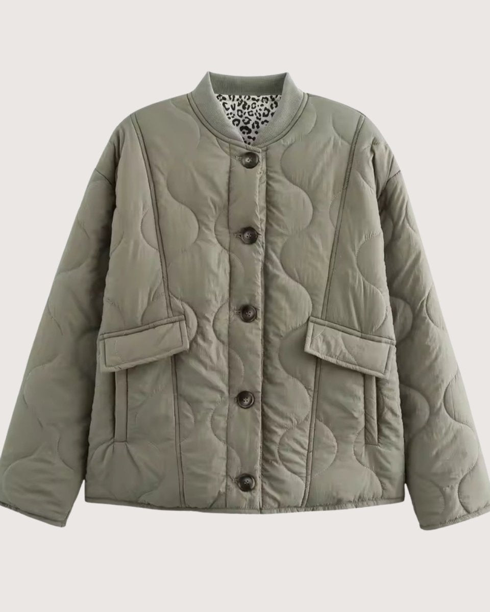 Flat lay product shot of the Harmony quilted jacket in sage green, showing the button front, patch pockets, and leopard print interior collar lining.