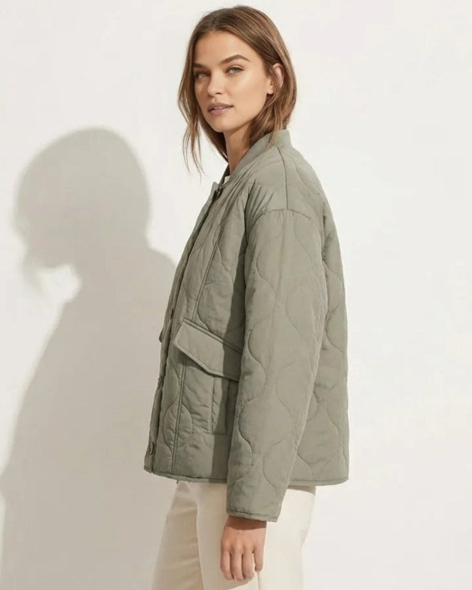 Side profile of a model in the Harmony sage green quilted jacket, highlighting the sleeve volume and patch pocket detail.