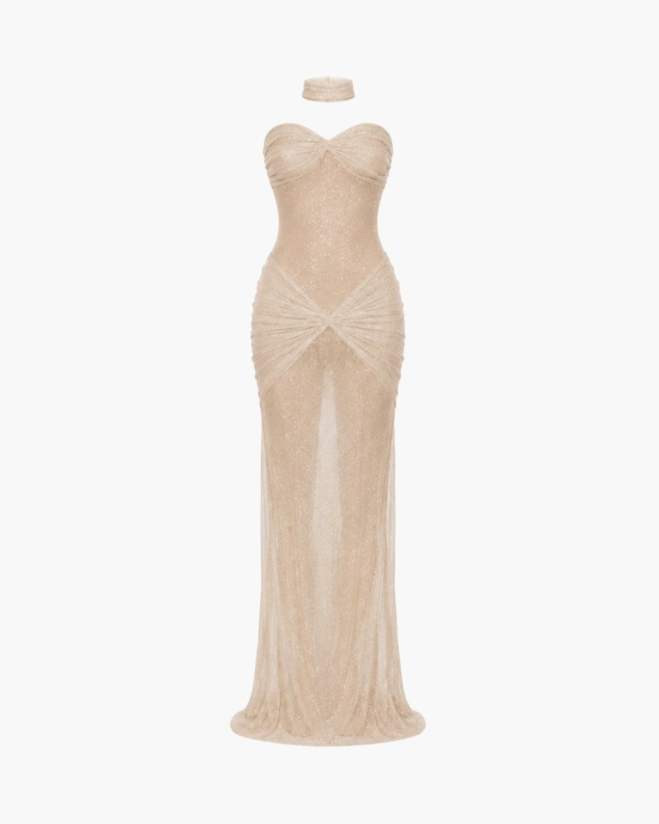 A strapless champagne beige maxi gown with a sweetheart neckline, fitted silhouette, and a sheer textured overlay, displayed on a headless mannequin against a plain white background.