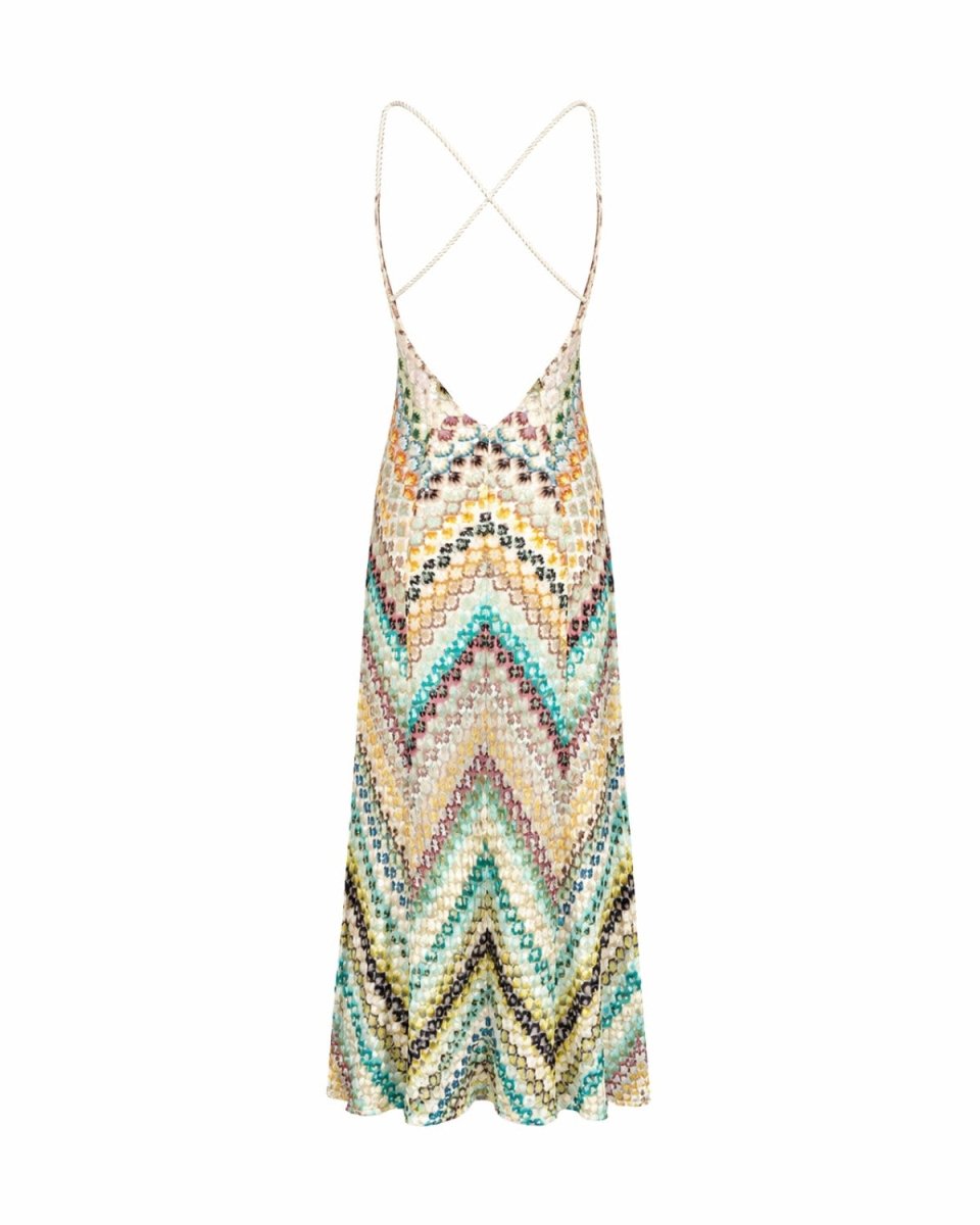 A sleeveless knit slip dress with a colorful chevron pattern in beige, green, blue, and brown, featuring thin spaghetti straps that cross at the back.