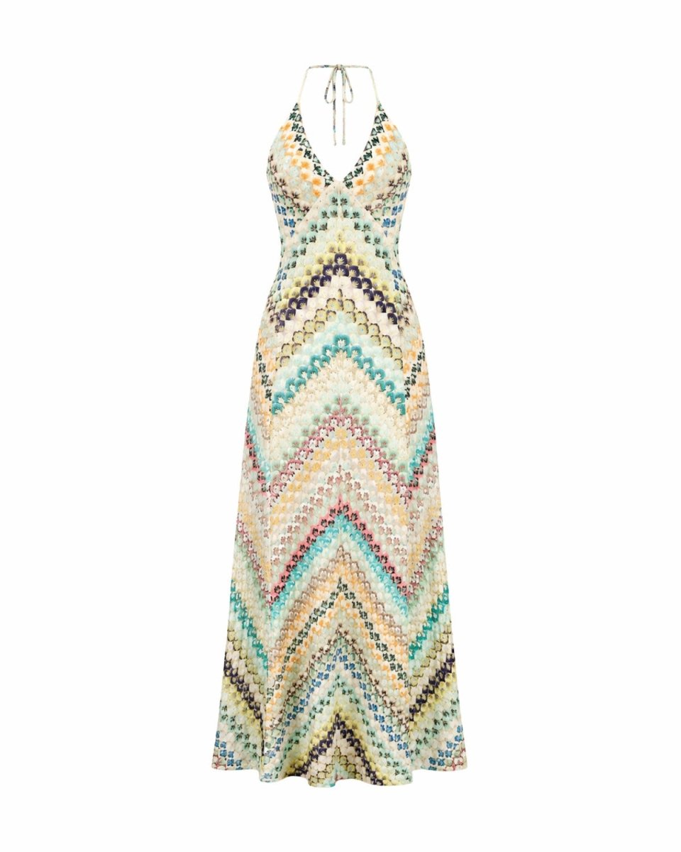 A sleeveless halter-neck maxi dress with a colorful chevron pattern in shades of teal, yellow, orange, purple, and beige on a white background.