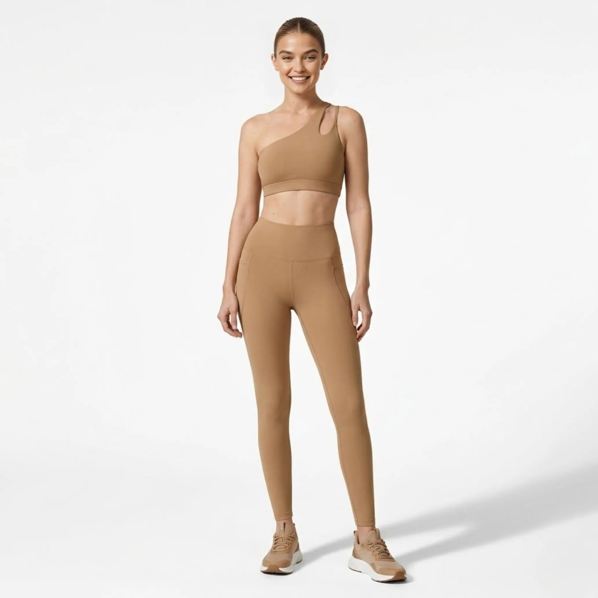 Front view of woman wearing Kouvr khaki  asymmetrical one shoulder sports bra and high waisted legging activewear set