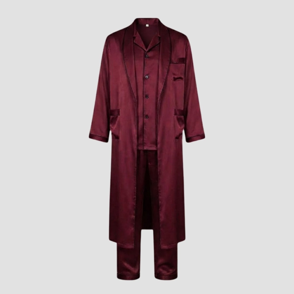 Flatlay of the Kouvr 3-piece men's sleepwear set in burgundy, including the robe, button-down shirt, and trousers with contrast piping detail. 