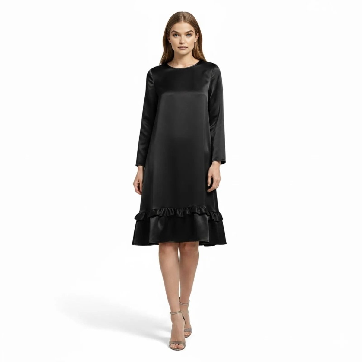 Model wearing the Kouvr Adalee black satin long sleeve midi dress with a ruffle hem, front view.