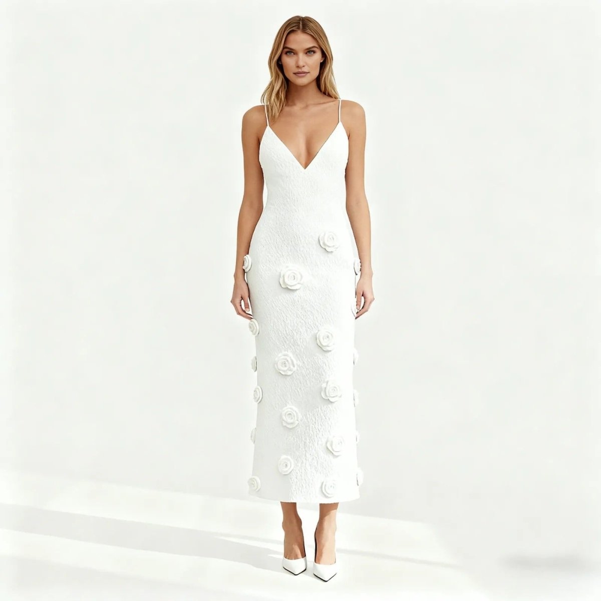 White kouvr dress with button details on a light gray background.