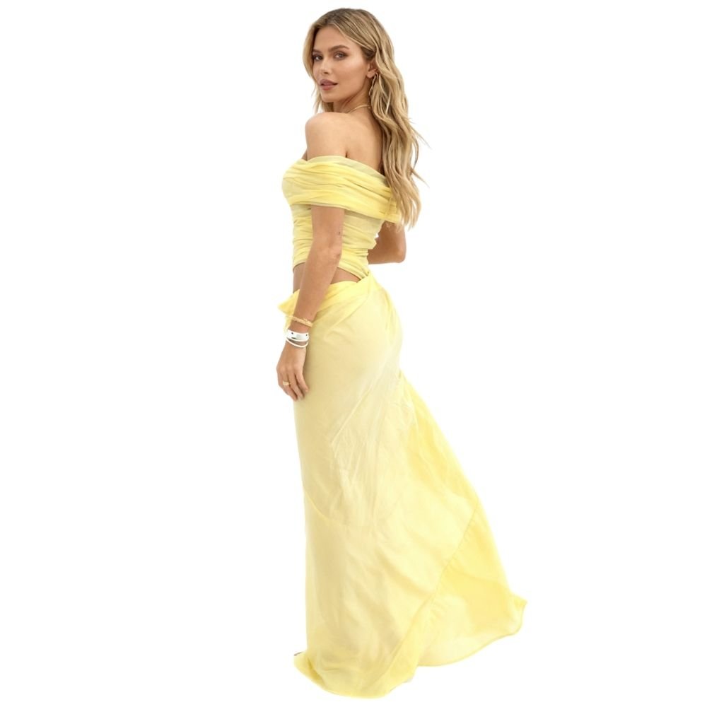 Side view of the Anita yellow draped mesh gown, showing the waist cutout and asymmetric skirt.
