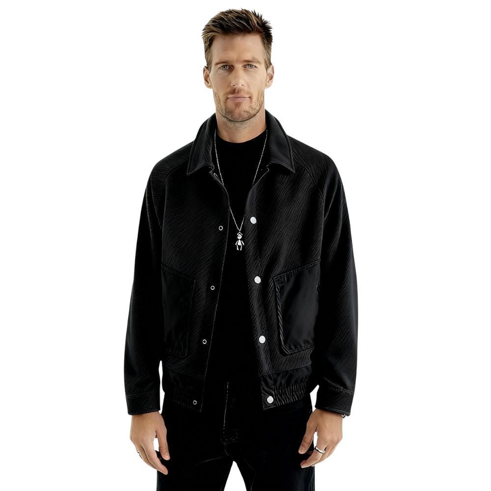 Man wearing a black kouvr jacket on a white background