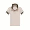 Flatlay product shot of the Kouvr pink polo shirt with its signature black and gold monogram check collar and embroidered chest logo.