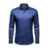 Front flat lay of the Kouvr long sleeve men's dress shirt in slate navy blue, showing the collar and button placket detail.