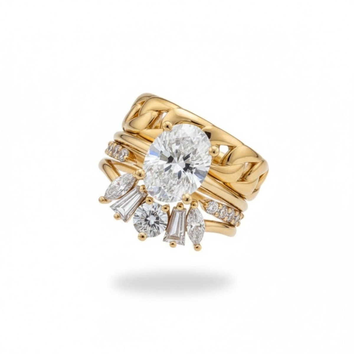 The complete Kouvr Emersyn four-piece diamond ring stack, featuring a central oval diamond solitaire, a multi-shape diamond crown band, a pavé band, and a chain link ring in 18K yellow gold. 