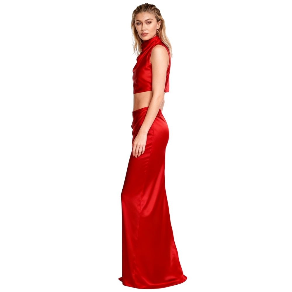 Woman wearing a red Kouvr two-piece outfit on a white background