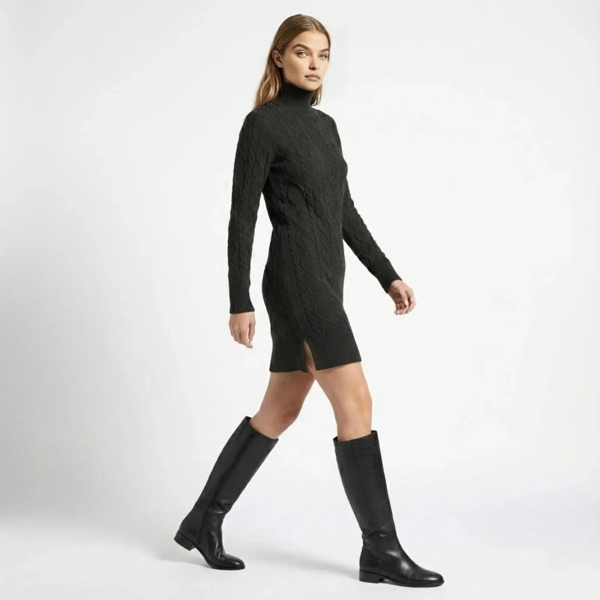 Side profile of a model walking in the black cable-knit turtleneck dress, showcasing the movement, side slit detail, and above-the-knee length. 