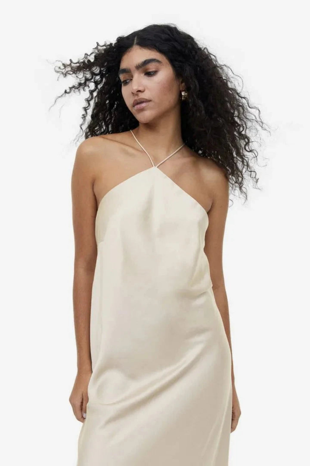 Model from behind wearing the Kouvr Fashion Cathalina beige satin halter dress showing the open back and criss-cross straps