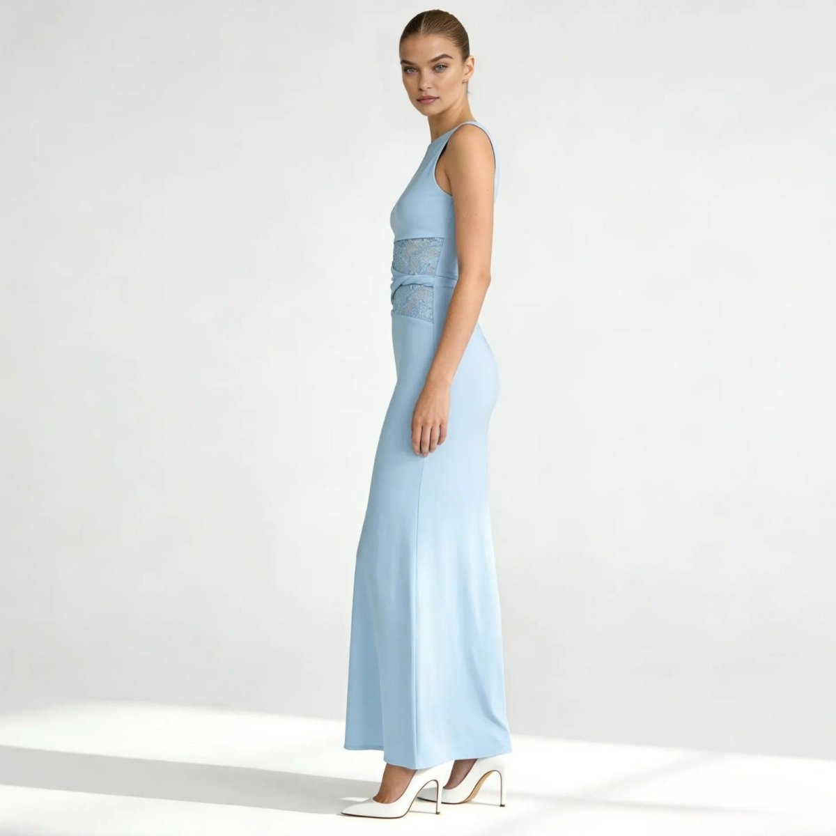 Side profile of the light blue Deborah  formal gown, highlighting the sleek column silhouette and lace paneling at the waist.

