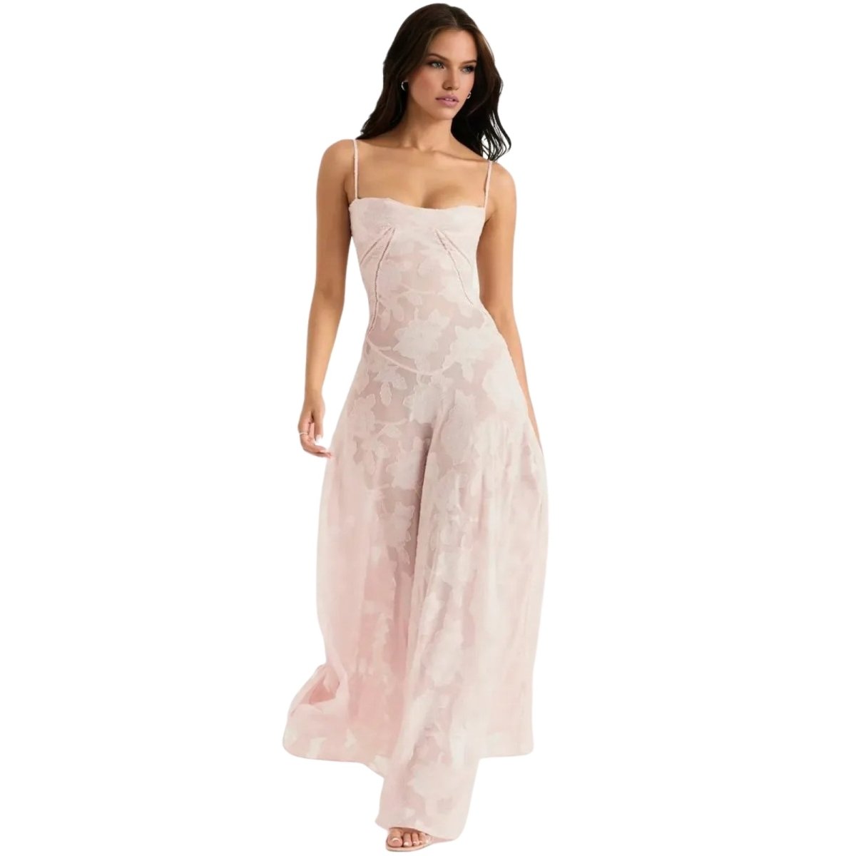 Woman wearing a long, light pink Kouvr dress on a white background