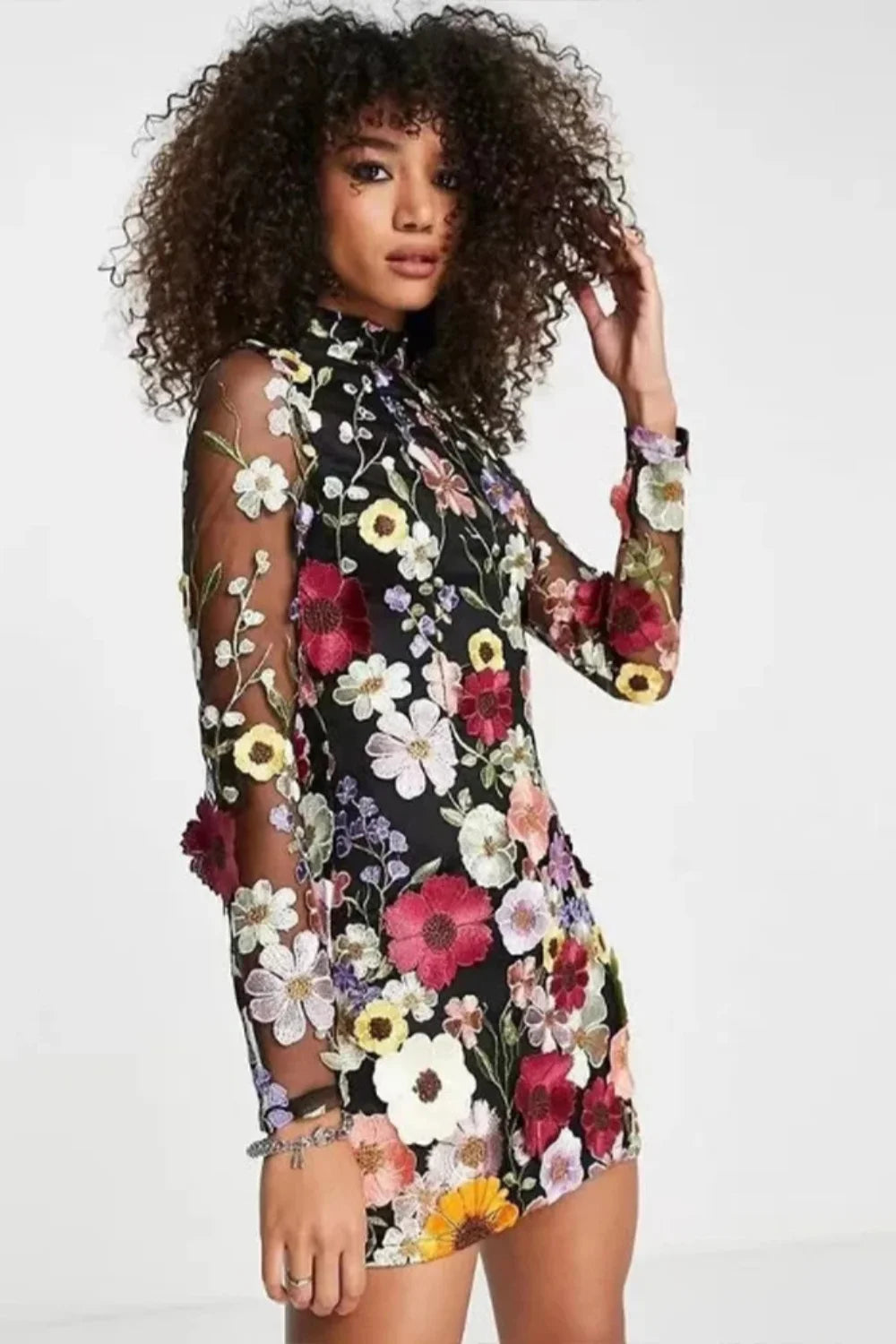 Model in Kouvr Fashion high neck black mini dress with vibrant multicolor 3D floral appliqué embroidery
