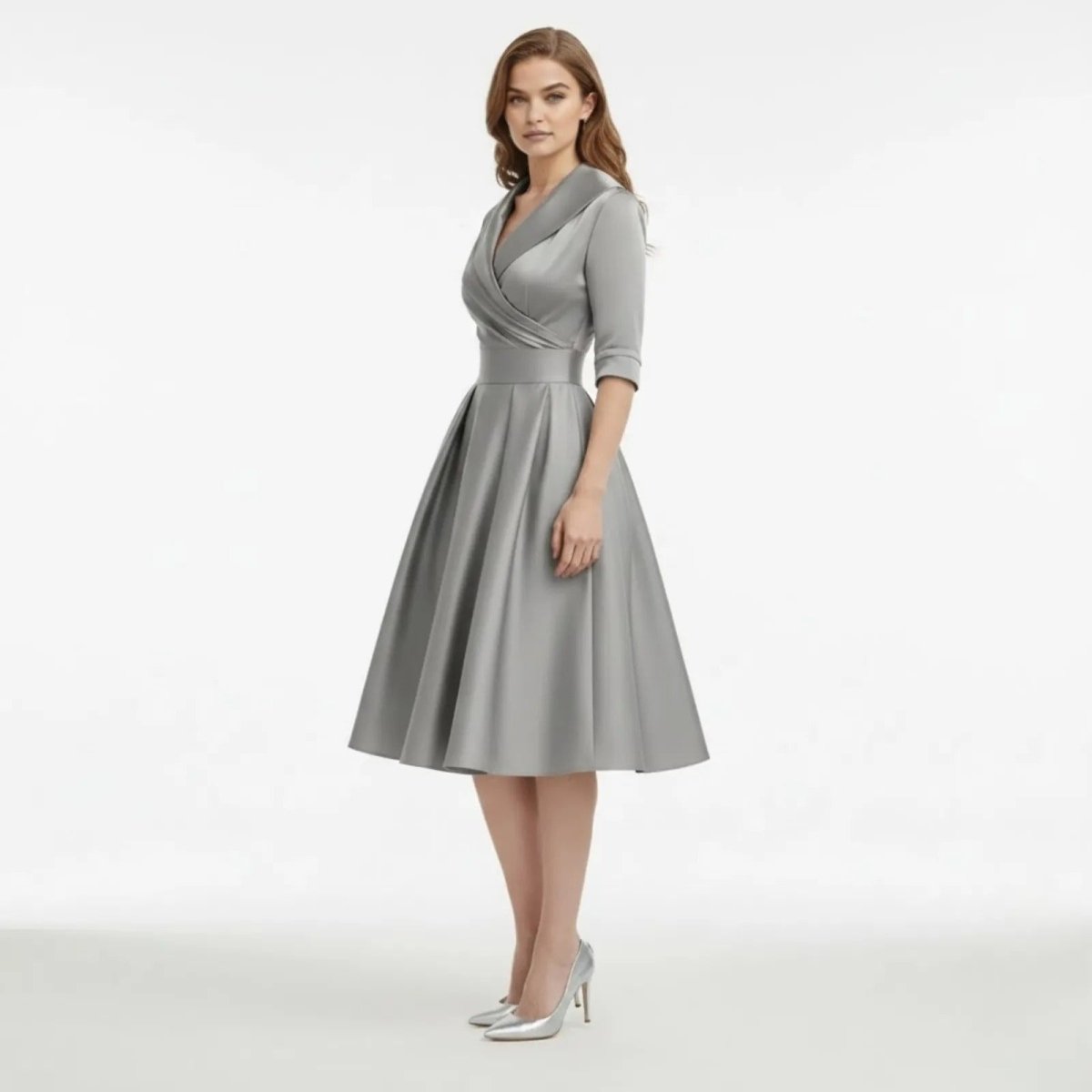 Model wearing the Kouvr Fashion Jenner grey satin A-line dress in a three-quarter view, highlighting the full pleated skirt. 