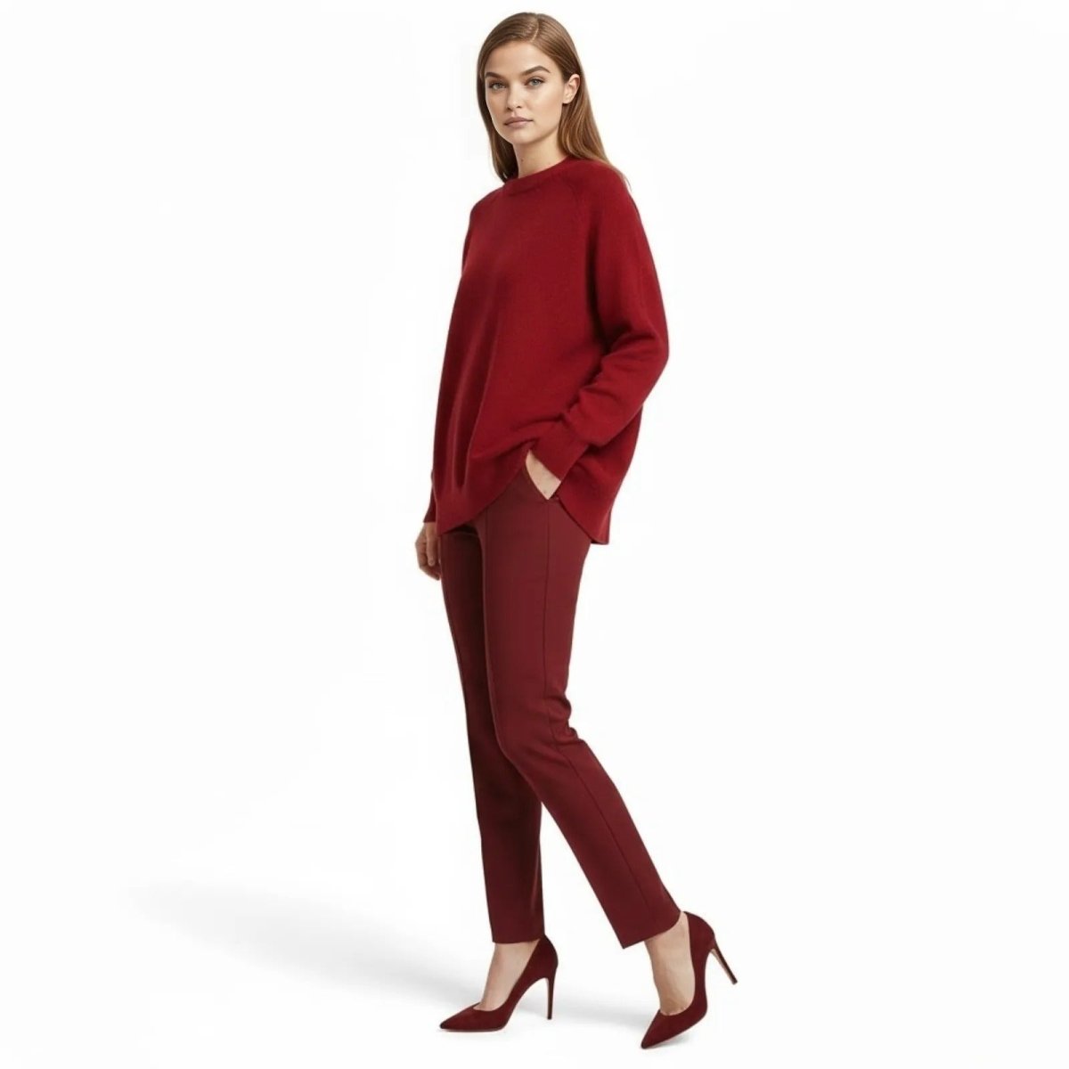 Side profile of a model wearing the Kouvr Fashion crimson red oversized sweater, showing the relaxed drape and tunic length.
