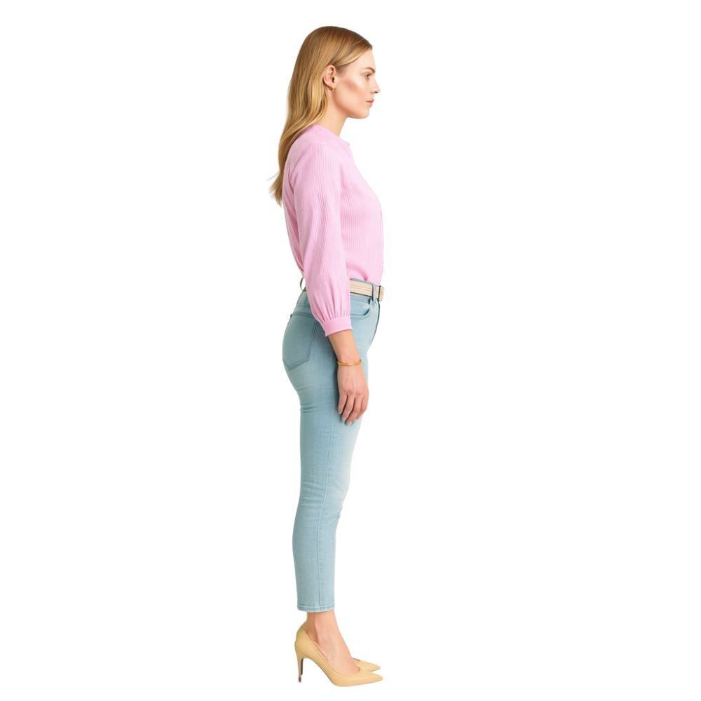Model wearing the Kouvr Fashion Ruffle Neck Blouse, tucked into high-waisted light-wash jeans