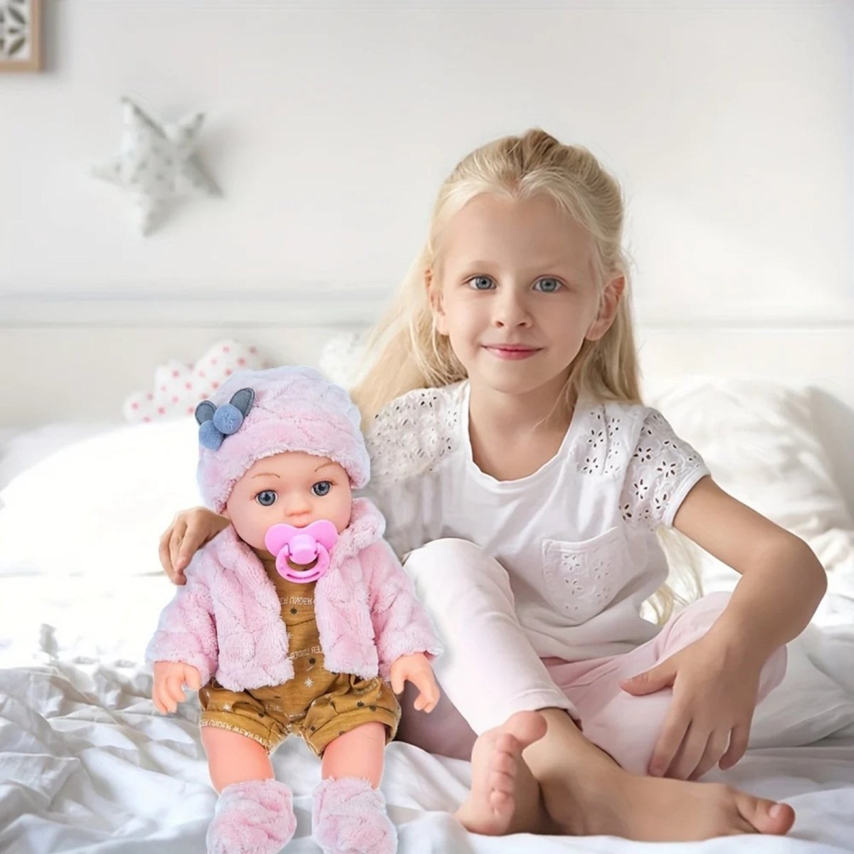 Kouvr Young girl sitting on a bed with a doll wearing a pink outfit.