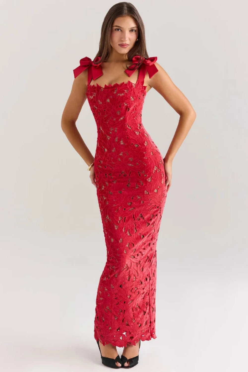 Back view of the Kouvr Fashion Penelope lace gown showing the rear slit and bow strap detail