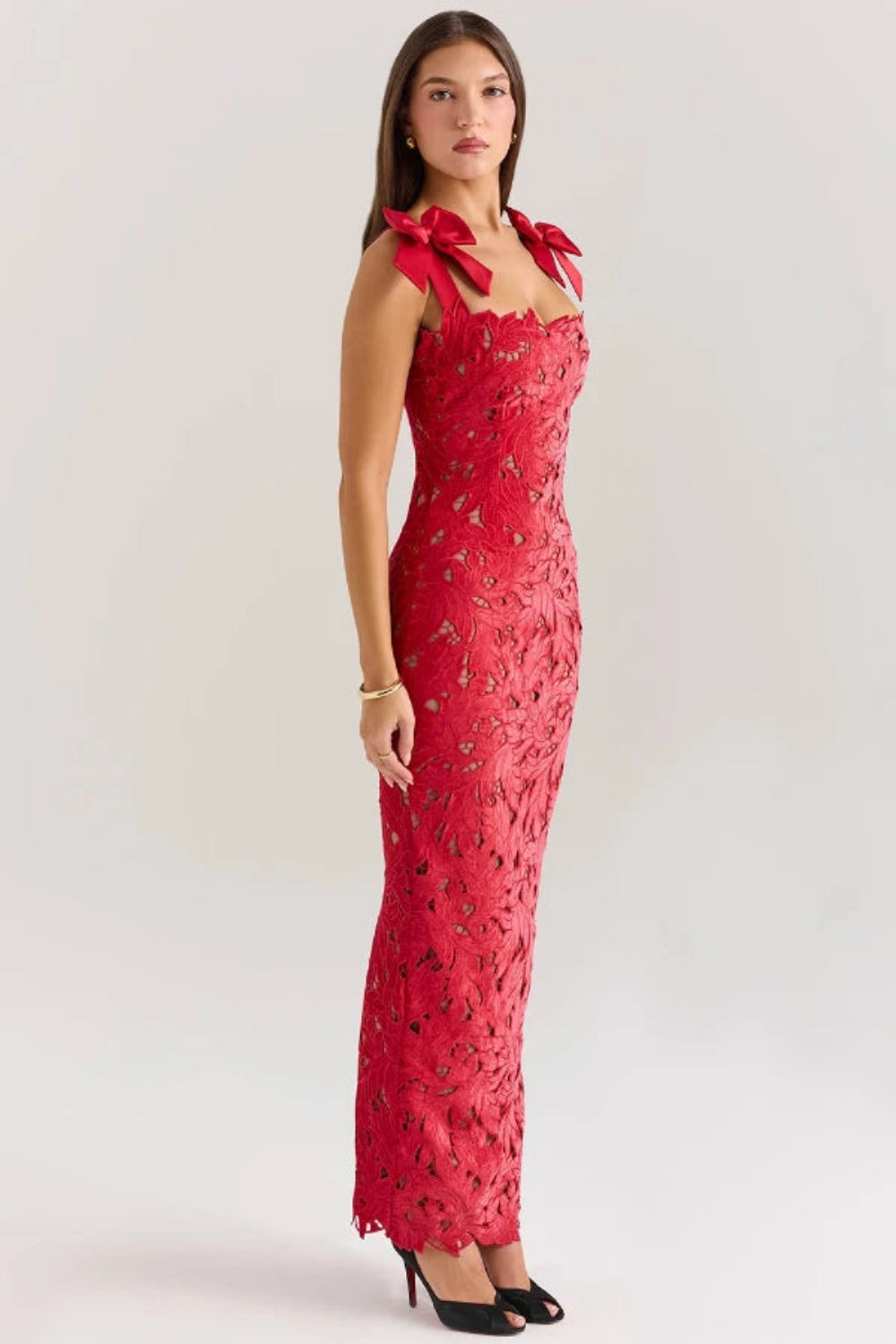 Back view of the Kouvr Fashion Penelope lace gown showing the rear slit and bow strap detail